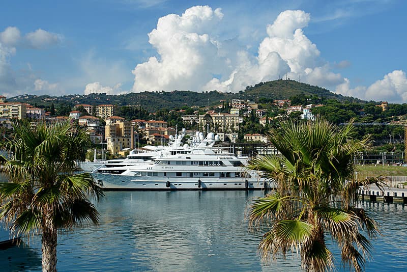 A yacht in between two palm trees in Imperia