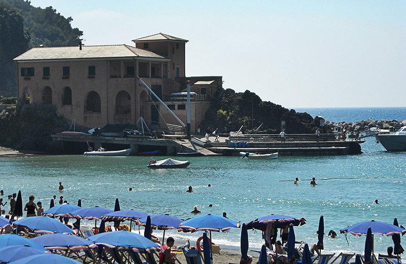 A view of a house, sea and beach in Lerici