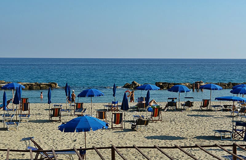 Sun chairs in the sandy beach of Arma di Taggia