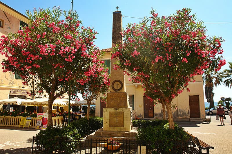 An old sculpture and flower trees in Riva Ligure