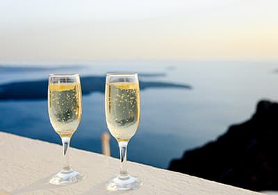 A glass of sparkling wine with a beautiful view of the sea in Liguria