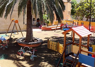 Colorful playground in Liguria under the palm trees